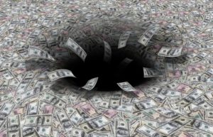 money disappearing down a black hole.